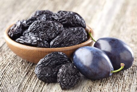 Prunes on wooden background