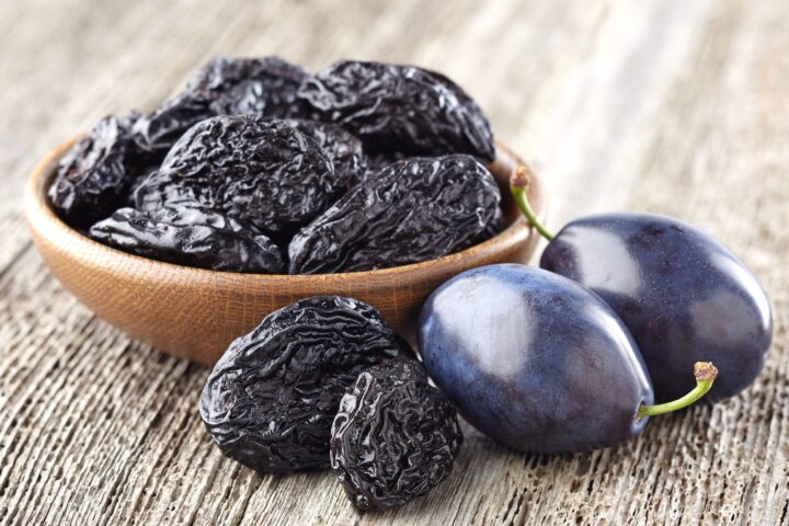 Prunes on wooden background