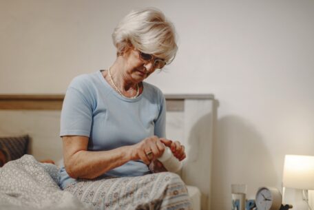 Senior woman taking a medicine before bedtime.