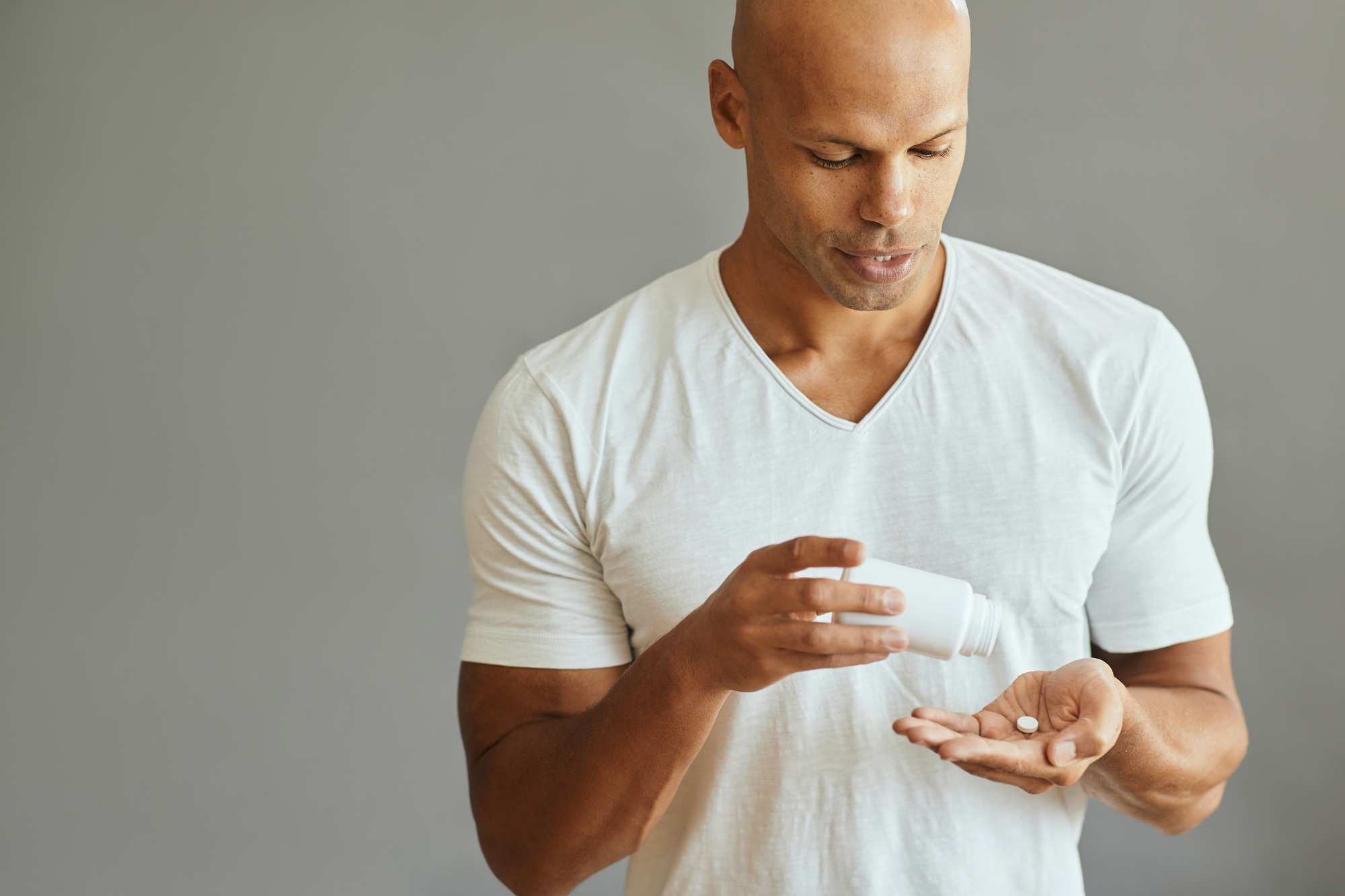 Young African American man taking a medicine.