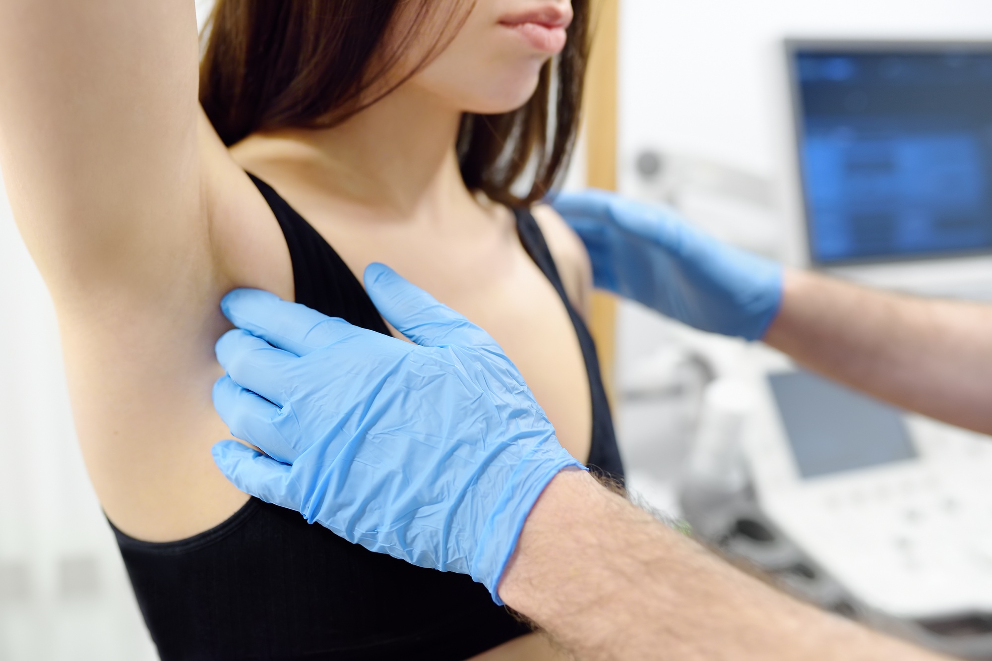 Doctor mammologist examines woman breasts and lymph nodes.